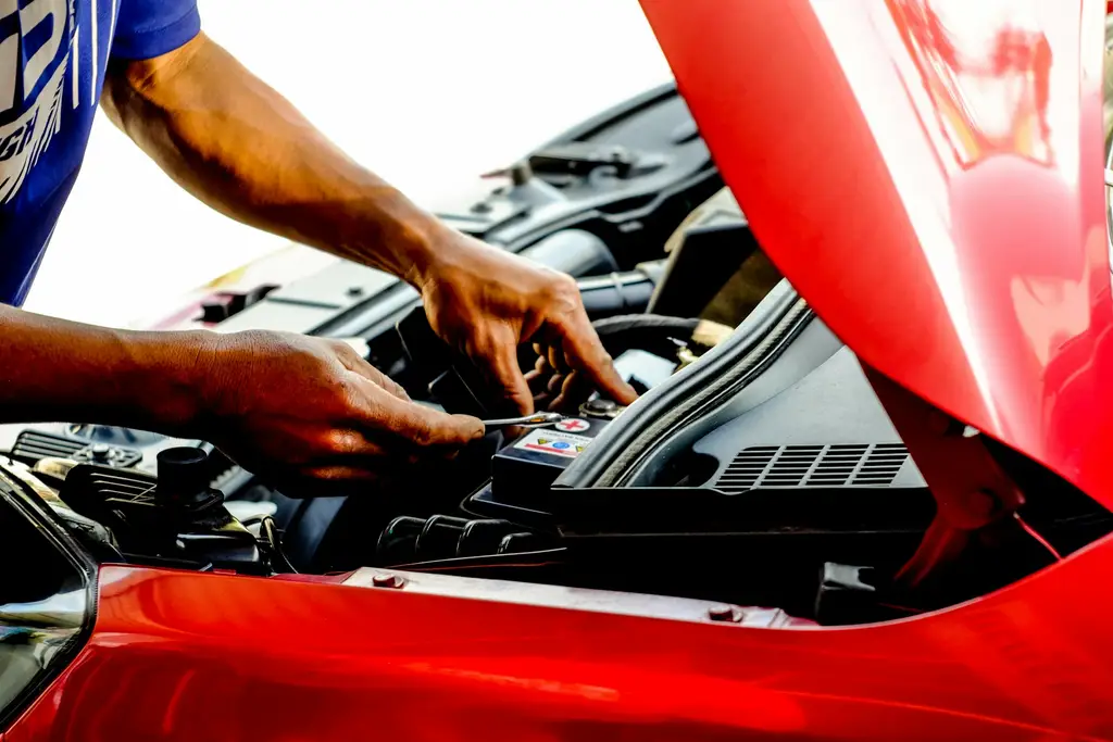 Mechanic working under the bonnet of a car at Billingshurst MOT & Service Centre